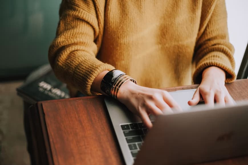 Person types on a laptop